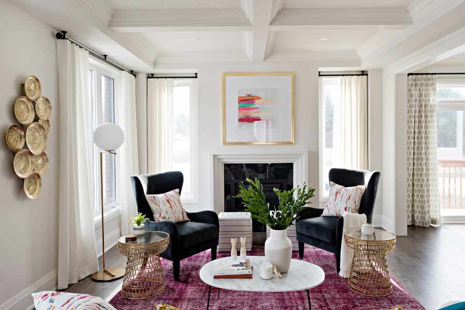 designer formal sitting room with reddish, pink accents and gold metal